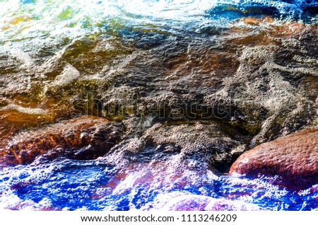 Stones in the water. Abstract texture with light leaks.