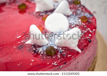 Strawberry Cake dessert with candies on wooden background