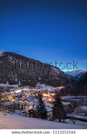 Small mountain village Filisur in Graubünden Switzerland during Night with moonlight in background