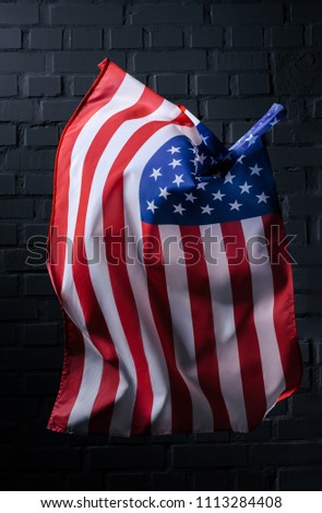 vertical waving united states flag in front of black brick wall, Independence Day concept