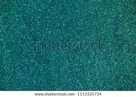 Turquoise background with small white and black spots