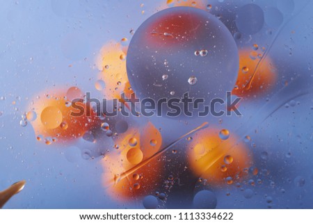 the texture of the background of the oil stains on the water circles yellow blue abstraction