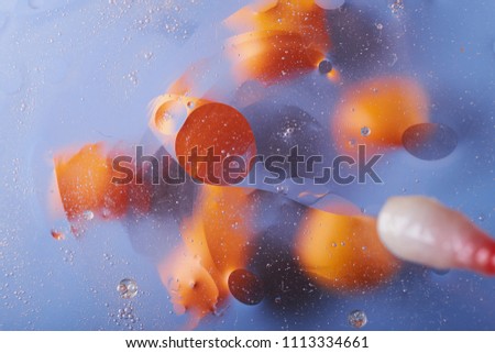 the texture of the background of the oil stains on the water circles yellow blue abstraction