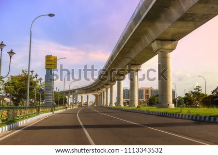 City over bridge with highway road at sunrise. Photograph shot at Rajarhat area of Kolkata, India.