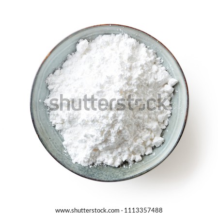 Bowl of powder sugar isolated on white background, top view Royalty-Free Stock Photo #1113357488