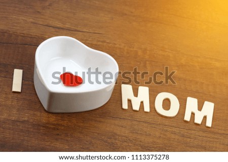 I love mom wording with pink flower on old wooden background, Mother's day concept.