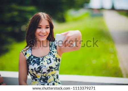 Close up sunny portrait of young happy pretty girl making selfie and smile, lovely emotions, long brunette hairs, perfect ski, bright make up.