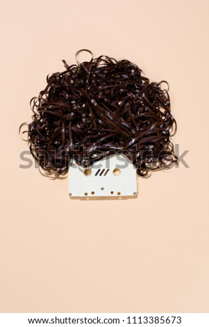 top view of retro audio cassette with tape isolated on beige