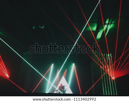 silhouettes of a musician at a disco, party, party. laser show, art performance. concept of nightlife. people at a meeting. Vintage photo processing