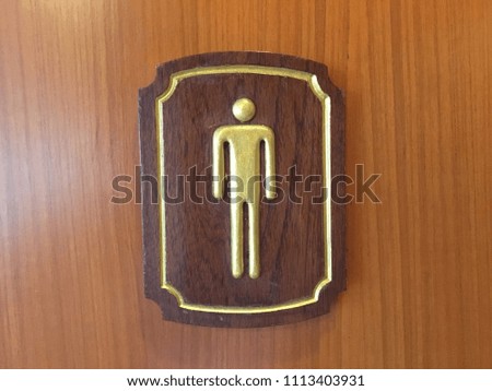 gentlemen toilet wooden sign on the wall