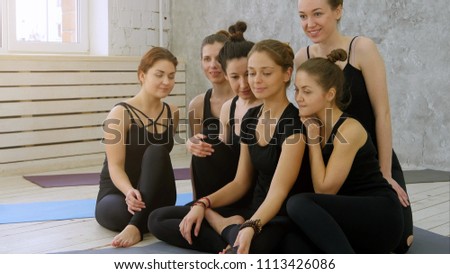 Group of young women taking selfie using cell phone at yoga class