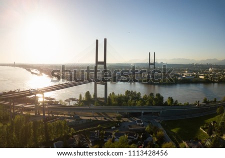 Aerial view of Alex Fraser Bridge during a vibrant sunny day. Taken in North Delta, Greater Vancouver, BC, Canada.