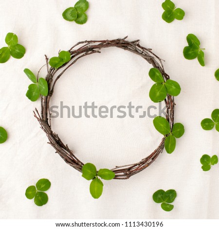 Floral composition. Wreath made of roools, leaves, and flowers on tissue white background. Rustic style of home decor, flat lay, top view. St.Patrick 's Day