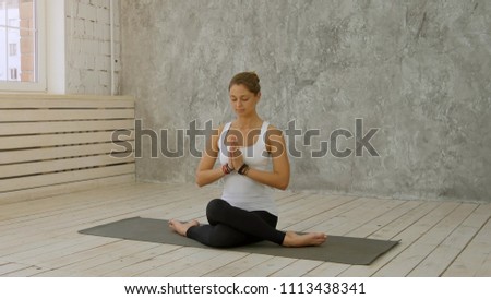 Woman doing Yoga at home - Marichyasana or Marichi's pose