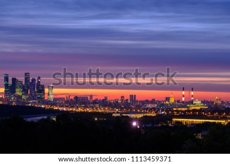 City panorama with night view on Moscow and international business center "Moscow city" on colorful sky background.