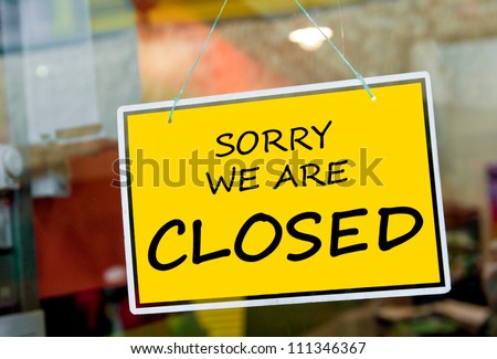 sorry we are closed sign hanging on a window door outside a restaurant, store, office or other Royalty-Free Stock Photo #111346367