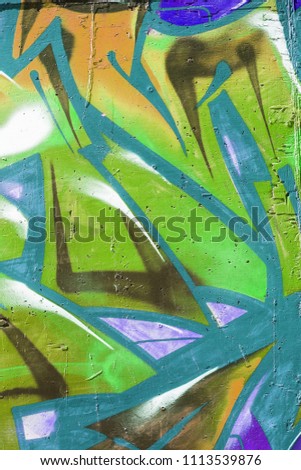 Beautiful street art graffiti. Abstract creative drawings of fashionable colors on the walls of the city. Urban contemporary culture. Abstract stylish drawing, label on the wall, fragment of graffiti
