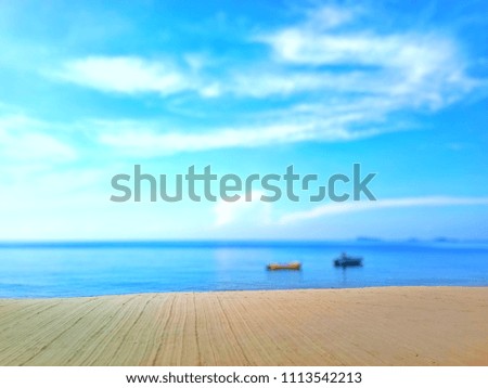 Sand with blurred sea sky cloud boat background. Copy space for display or montage your products. Summer and travel concept Royalty-Free Stock Photo #1113542213