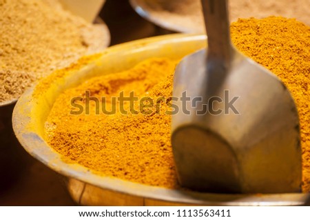 Traditional Indian curry powder spice mix in a bowl stock image. This spice blend is made of coriander, turmeric, cumin, fenugreek, and chili peppers. Sweet and aromatic Oriental spices.