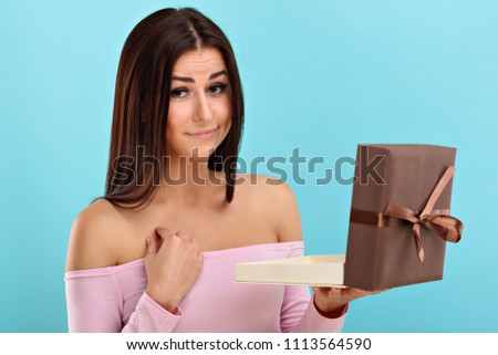 Woman against blue wall background