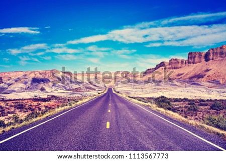 Vintage toned picture of a scenic road, travel concept, USA.