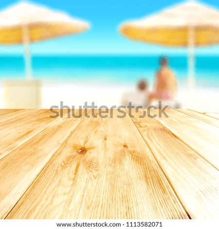 Table background of free space and beach background with people. 