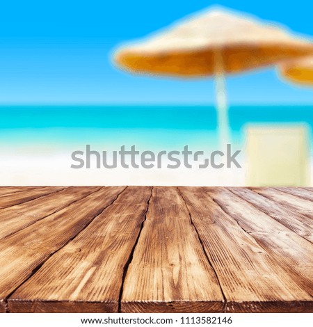Table background of free space and beach background with people. 