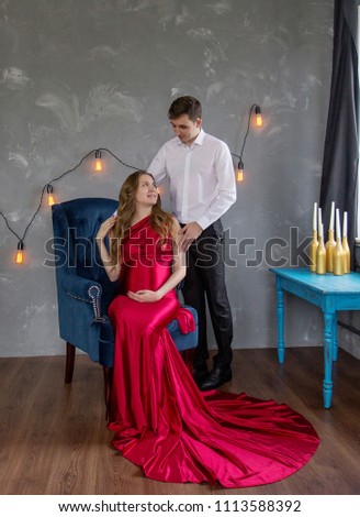 Pregnant wife with her husband in the room