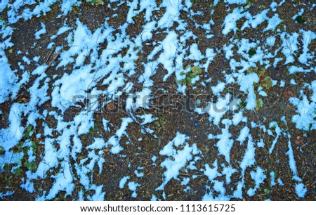 Snow lies on the grass. The background on the texture lies

