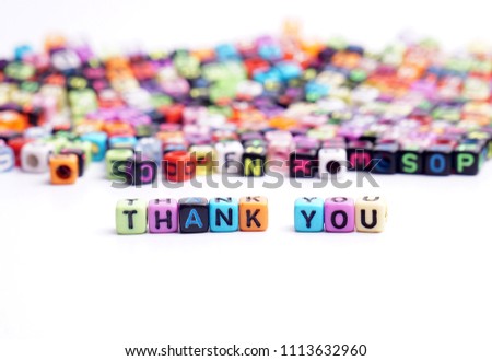 Colorful dice with word THANK YOU on white background