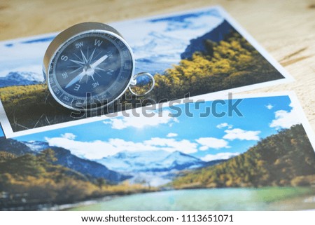 Compass on blur colorful nature photograph of popular tourist destination in autumn background, China traveling concept