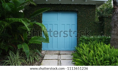 Blue gate  door to a garden 