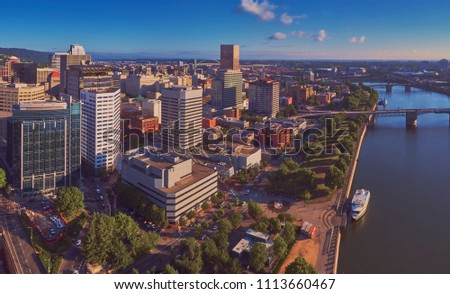 Drone aerial view of downtown Portland showing the World Trade Center Portland from Waterfront Park in early morning sun