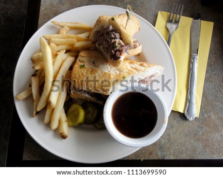 french dip sandwich.  In American cuisine, the French dip sandwich, also known as a beef dip, is a hot sandwich consisting of thinly sliced roast beef on a "French roll" or baguette. 