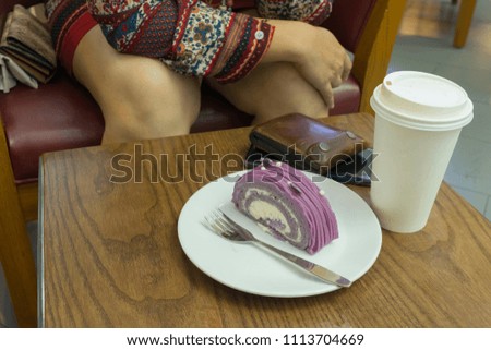 cake and paper cup fo coffee on table wood