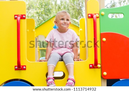 A pretty little girl on the playground.