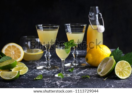 Lemonade liqueur Italian limoncello with lemons and limes
