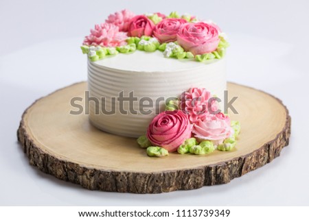 beautiful white cake and pink flowers cream on top ,white background