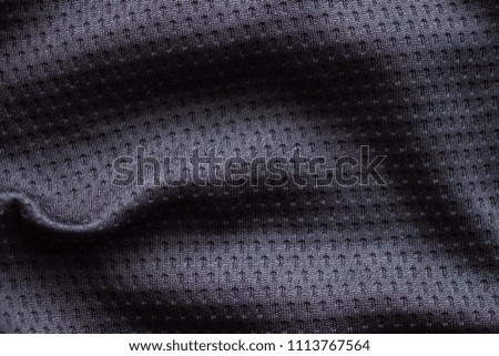 Black fabric sport clothing football jersey with air mesh texture background
