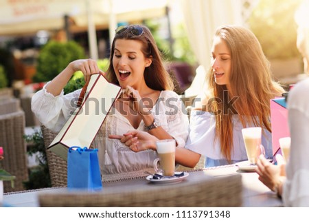 Happy girl friends in cafe during summer time