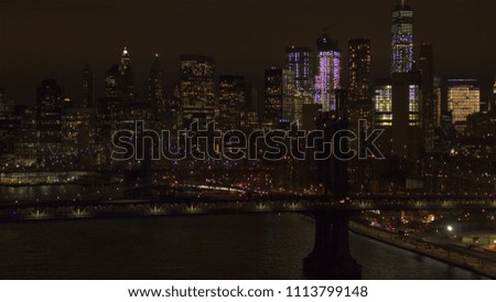 AERIAL: The two bridges lit up at night connecting Brooklyn & downtown Manhattan