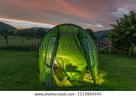 Tent lit up at night time on a campsite in Wharfedale in the Yorkshire Dales