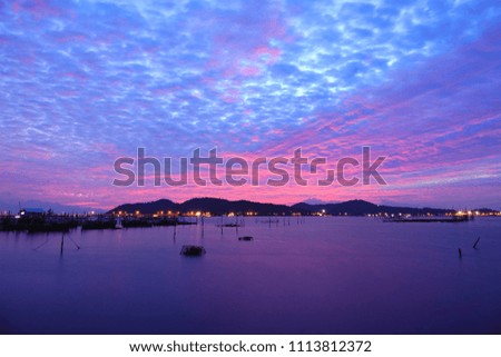 Long exposure shot of Lake view at Southern Thailand on sunset time background,Long exposure shot lake view with colored sky over lake on sunset time background.