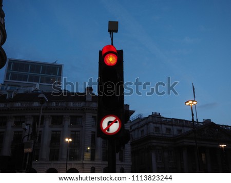 Traffic signal red light meaning stop. View at twilight blue hour before sunset