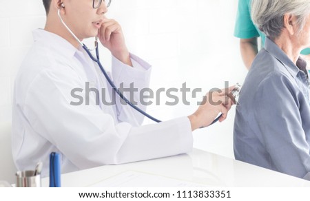 Asian doctor use stethoscope screening old patient female, elderly health check up 