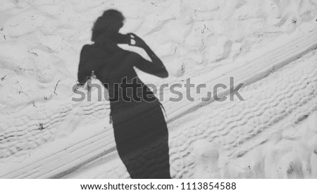Black and white gray silhouette one woman pretty slim girl sand beach minimalism diagonal taking mobile photo