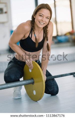 Girl carrying weights in gym