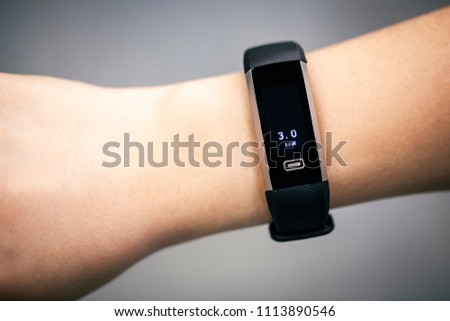 Fitness Activity Tracker With Heartbeat Rate on Woman's Hand 