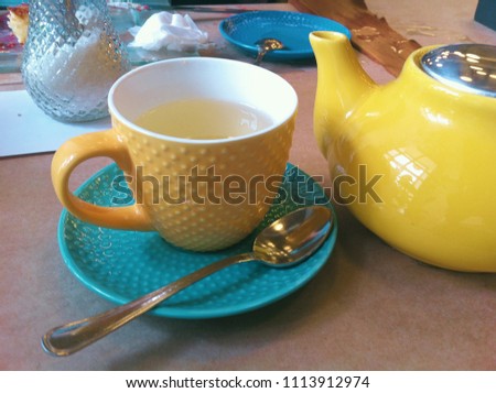 Breakfast in the cafe. Teapot, Cup and saucer. Bright, colorful colors. Close-up photo.