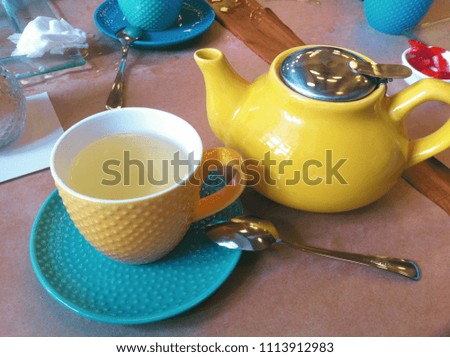 Breakfast in the cafe. Teapot, Cup and saucer. Bright, colorful colors. Close-up photo.